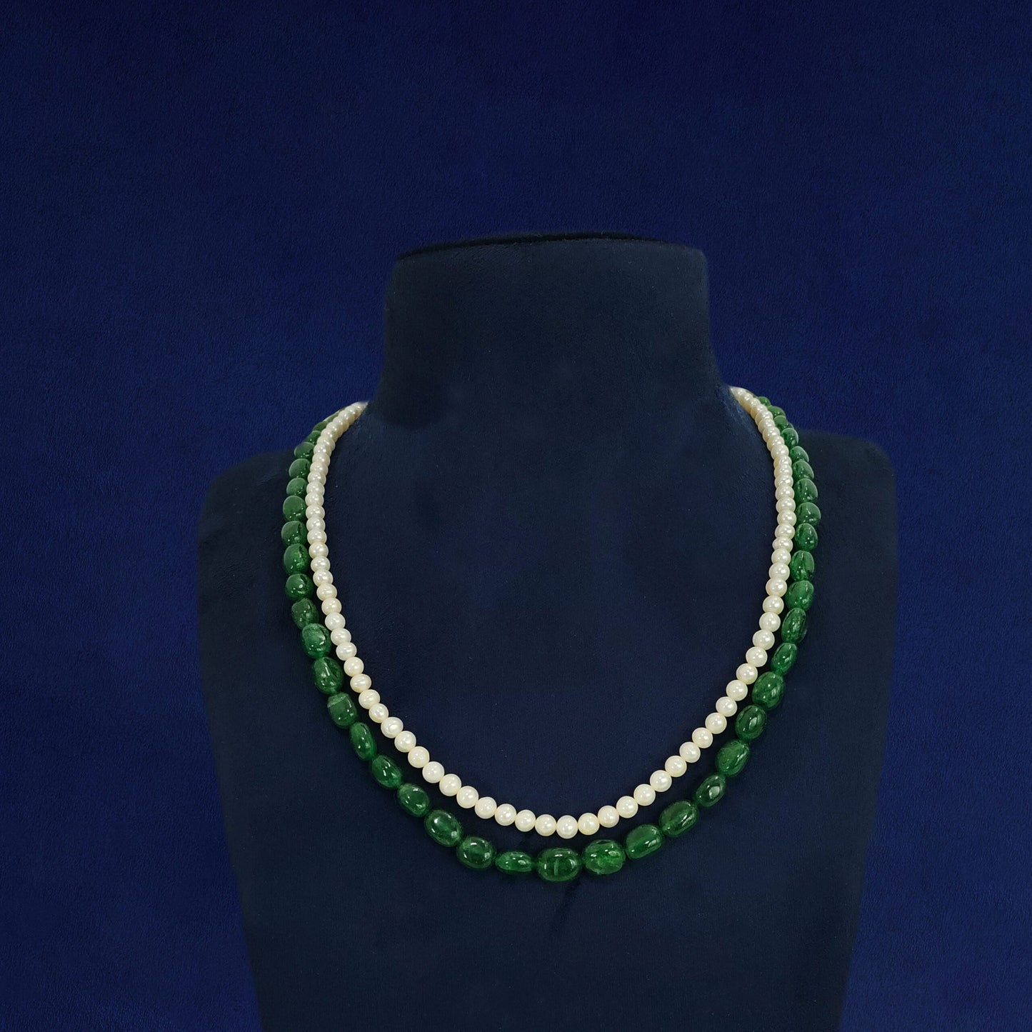 "Dual-line mala with white pearls and green beads for festive look"