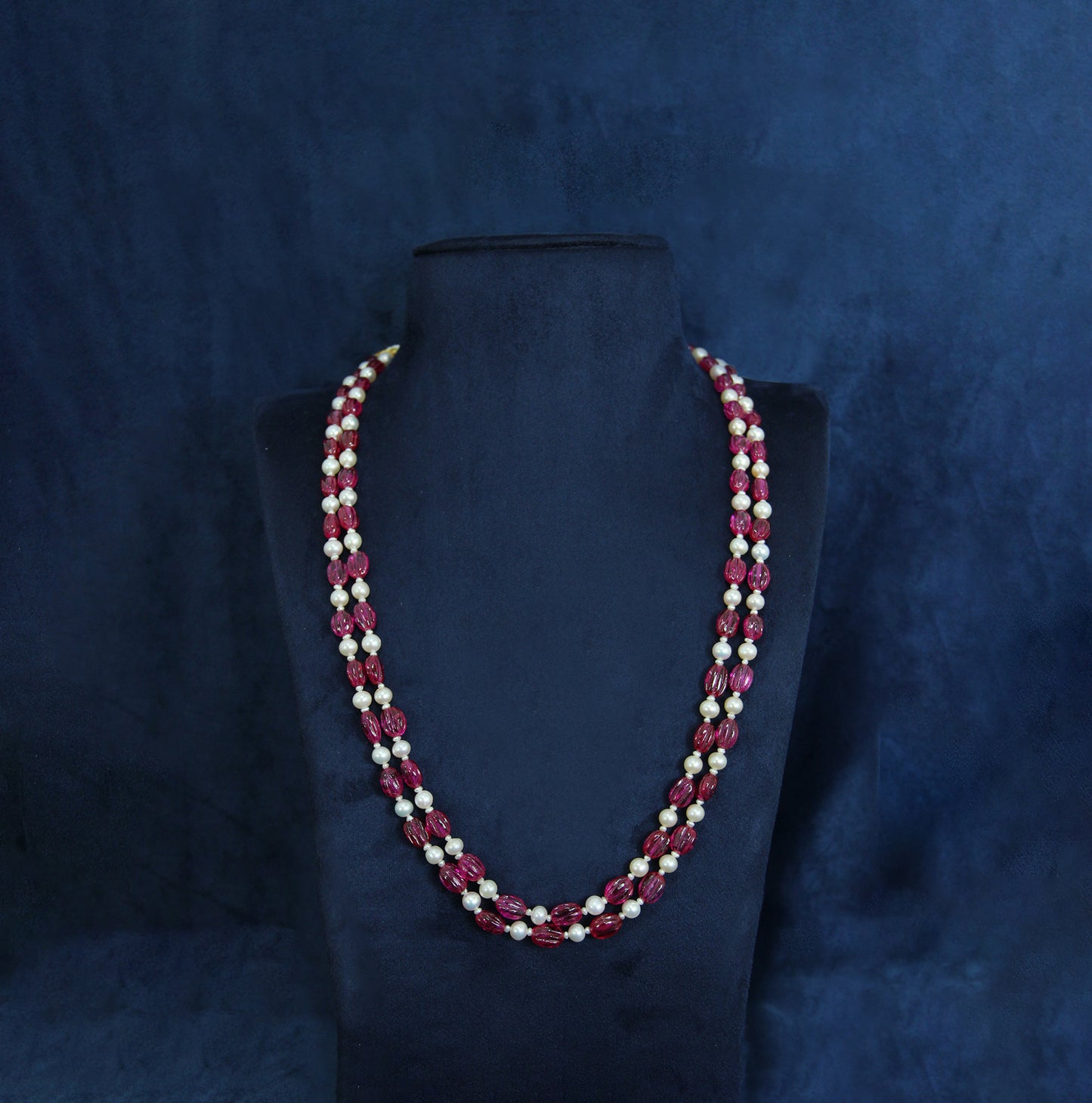 Dual-line classic mala featuring white pearls and ruby-colored beads.