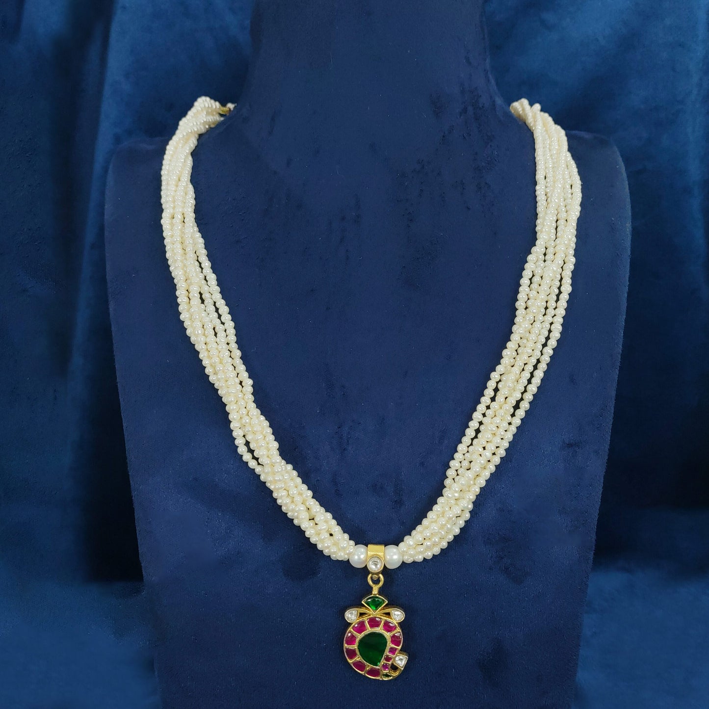 Multi-strand white pearl mala with an exquisite pendant for a classic look.