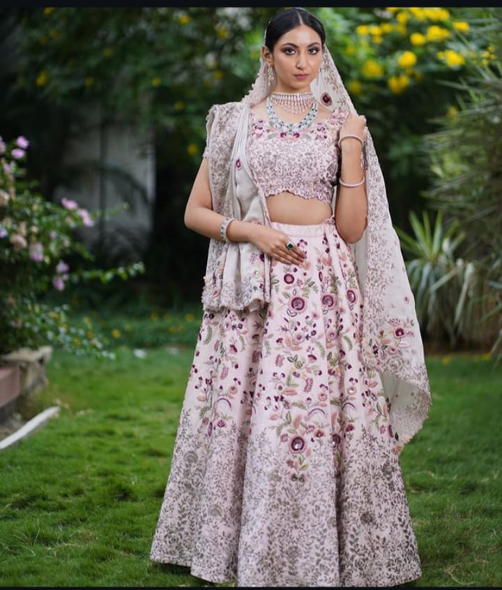 Bride wearing traditional Kundan jewelry with her wedding lehenga