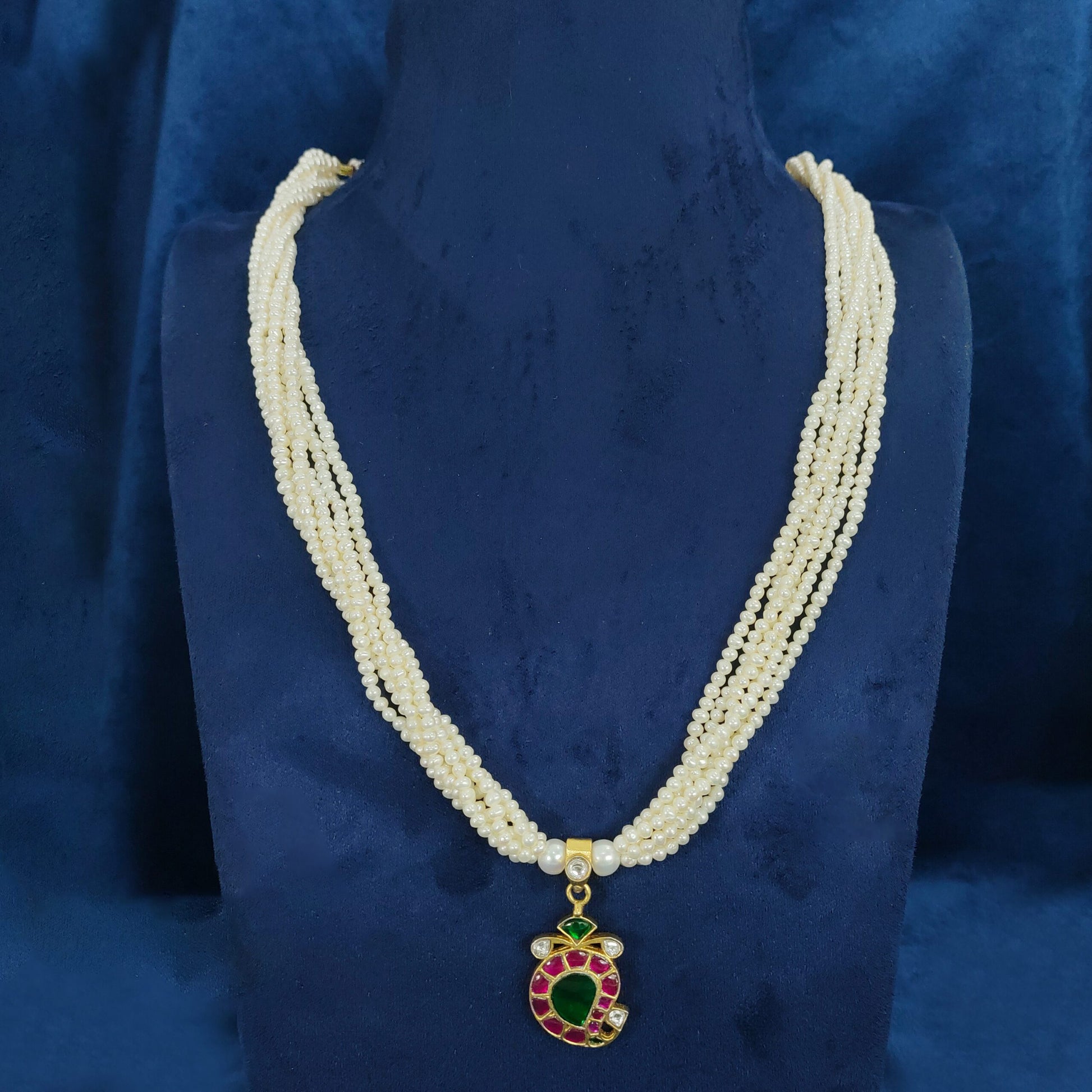 Multi-strand white pearl mala with an exquisite pendant for a classic look.