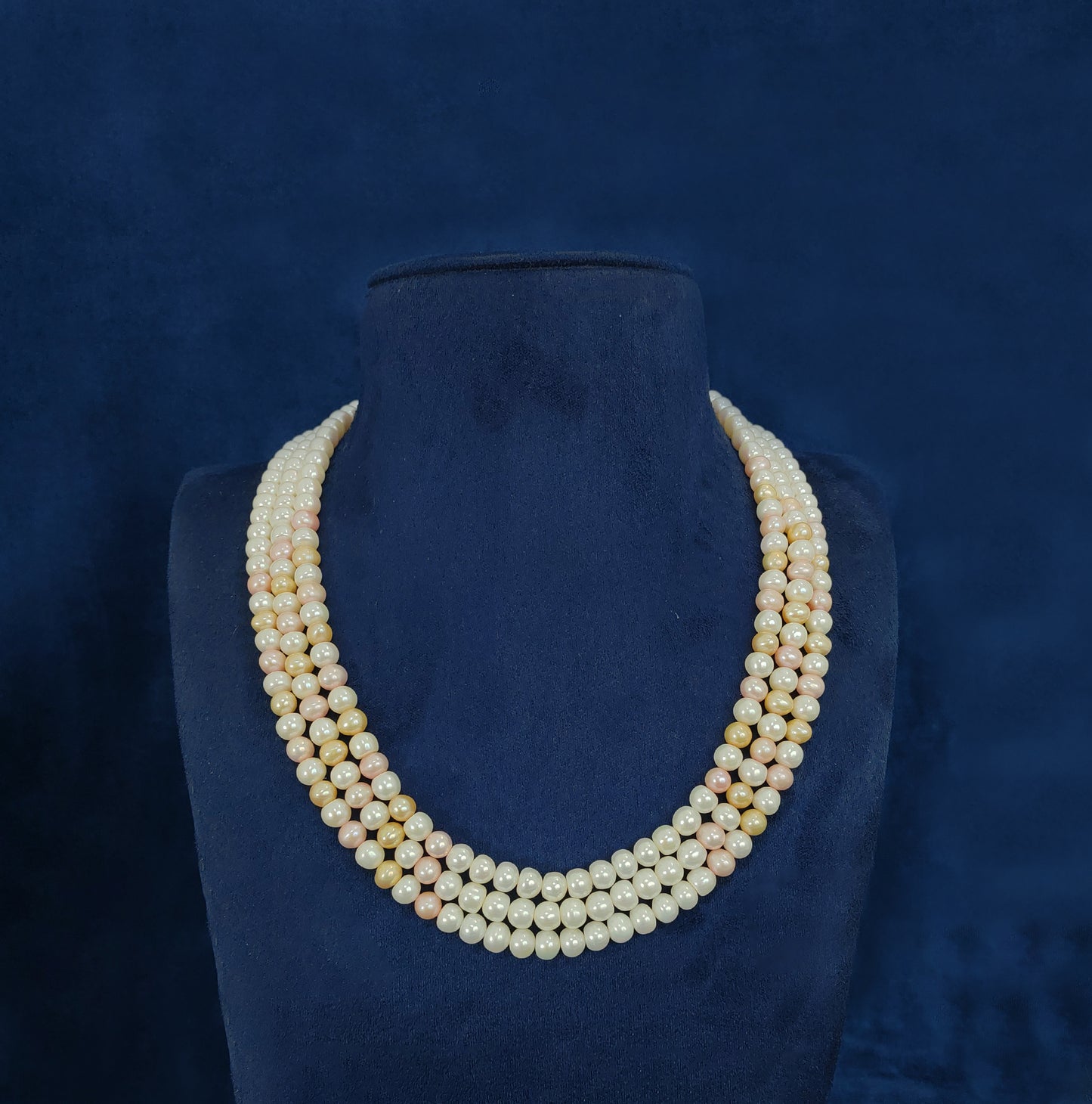 Three strand pearl mala with white, champagne, and pink pearls for special occasions.